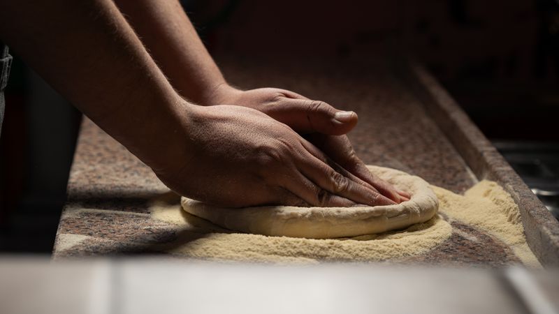 pizzafactory kitchen with chefs crafting handmade pizzas